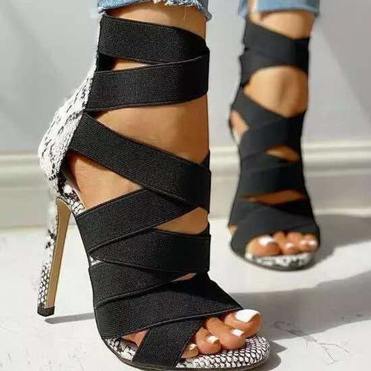URHER Odette black cross strap snake print stiletto heel sandals with microfiber interior.