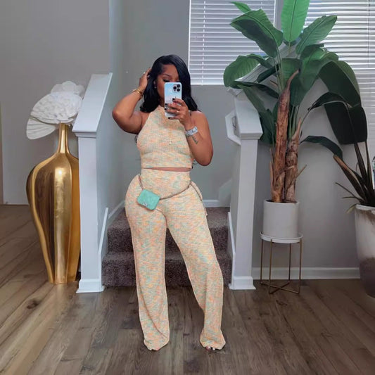 URHERHere woman in a pastel knit V-neck crop top and wide-leg pants set with side pockets.