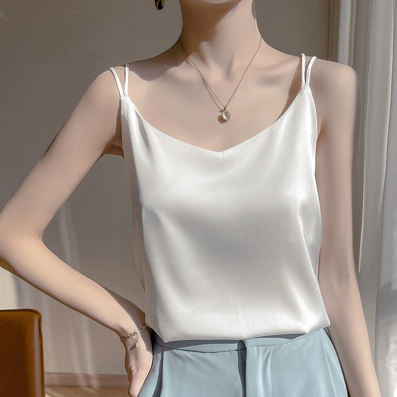 URBANCITY white silky camisole top with spaghetti straps and V-neckline, perfect for layering.