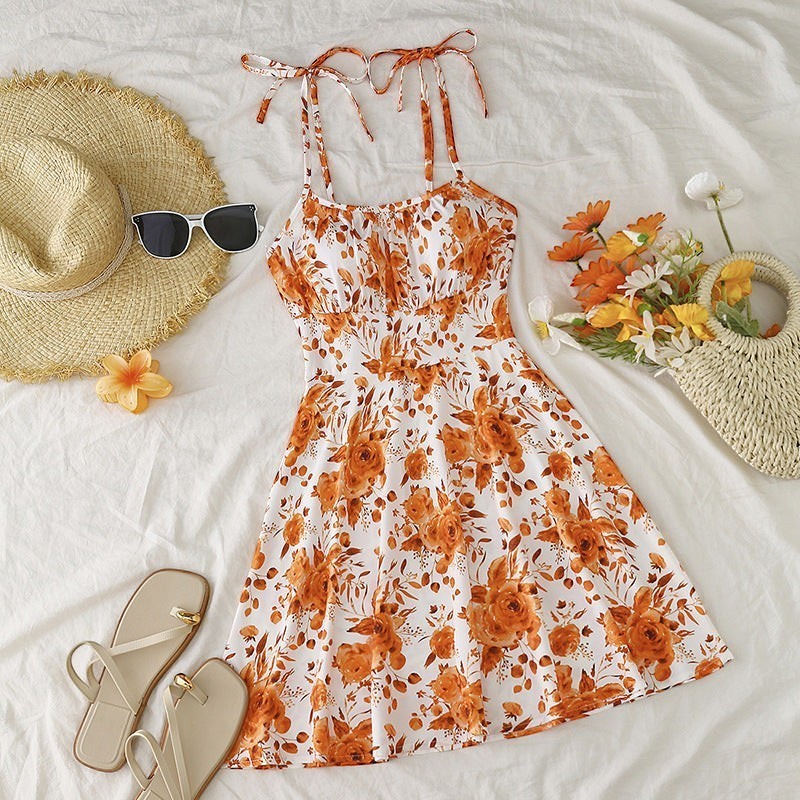 URH floral print sundress with elastic waist and tie straps, white with orange roses and leaves.