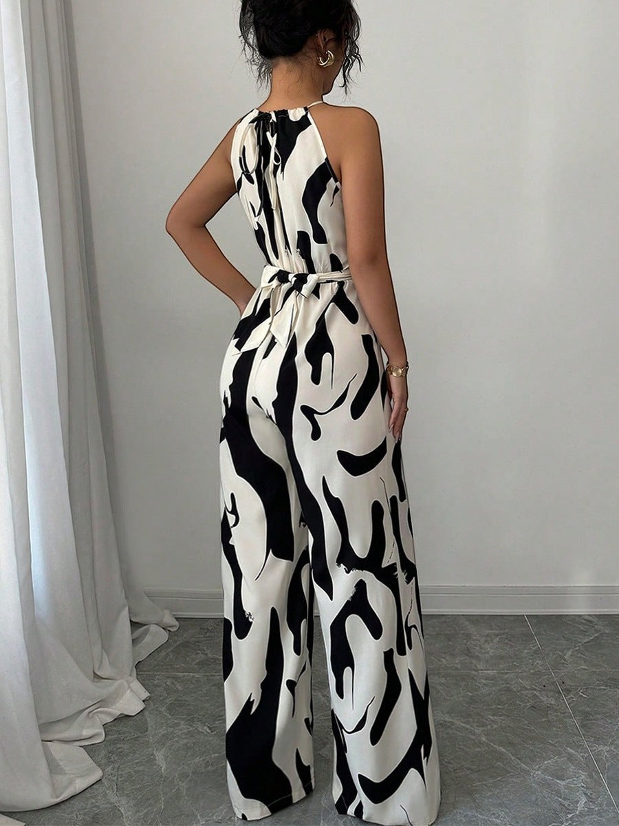 URHER Nia Utility Jumpsuit in black and white abstract print. Halter neck, belted waist, wide leg.