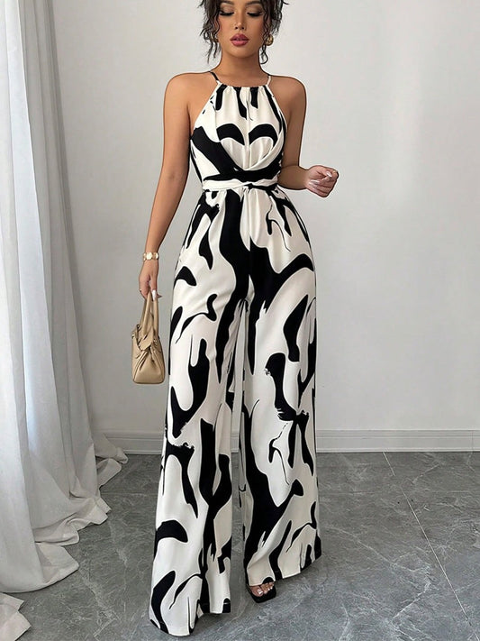 URHER Nia Utility Jumpsuit, a black and white abstract print wide-leg jumpsuit with a halter neck and belted waist.