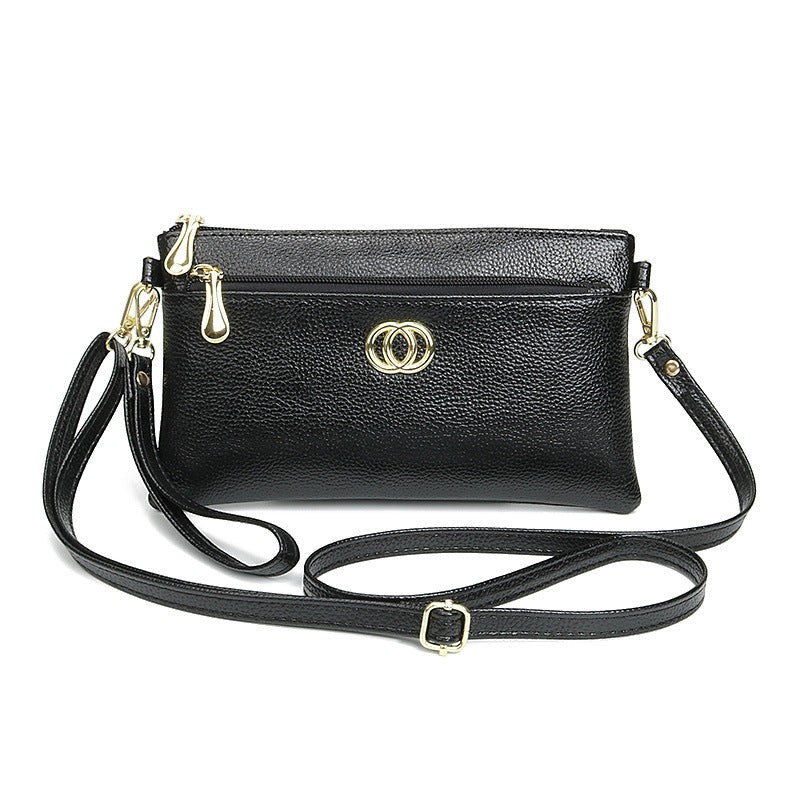 URHER Dion black pebbled leather mini crossbody bag with gold hardware and double zipper closure.