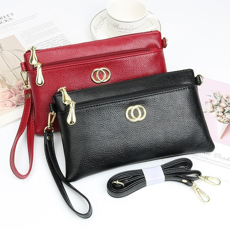 URHER Dion black pebbled leather mini crossbody bag with gold hardware and detachable strap.