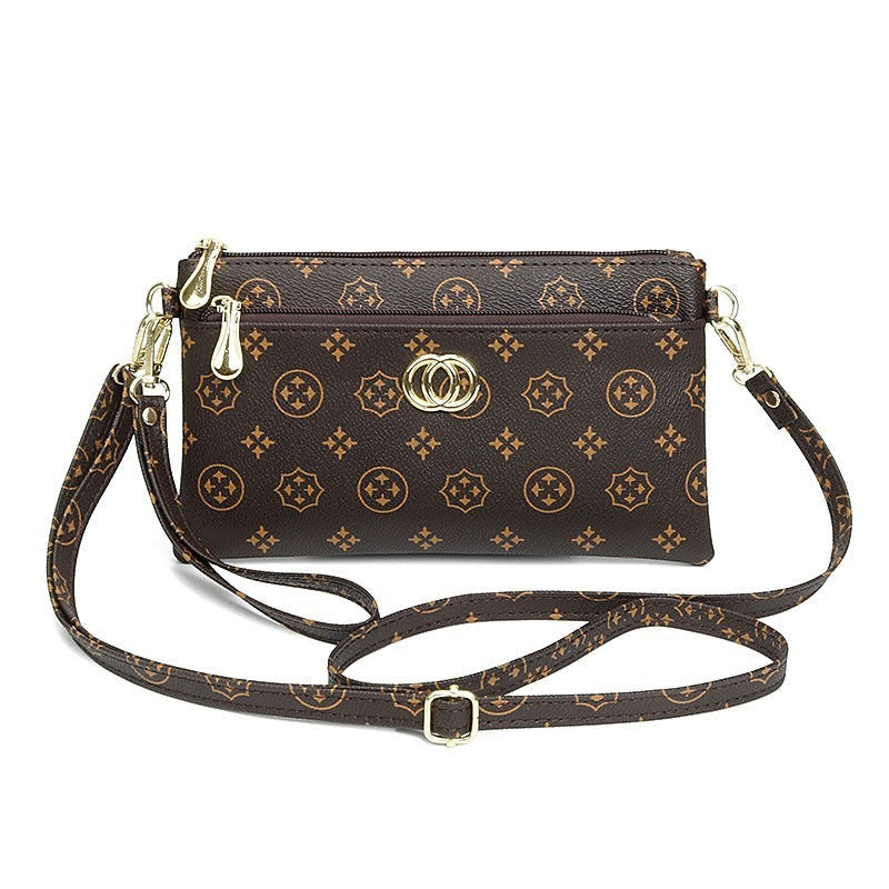 URHER Dion vintage print mini crossbody bag with gold hardware and adjustable strap.