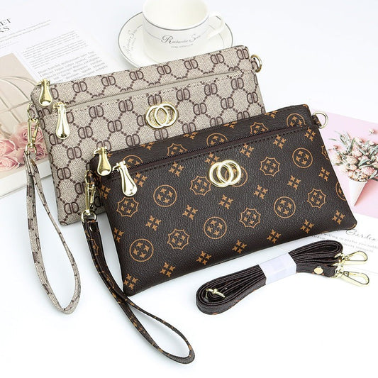 URHER Dion vintage print mini crossbody bag in brown and beige with gold hardware and detachable straps.