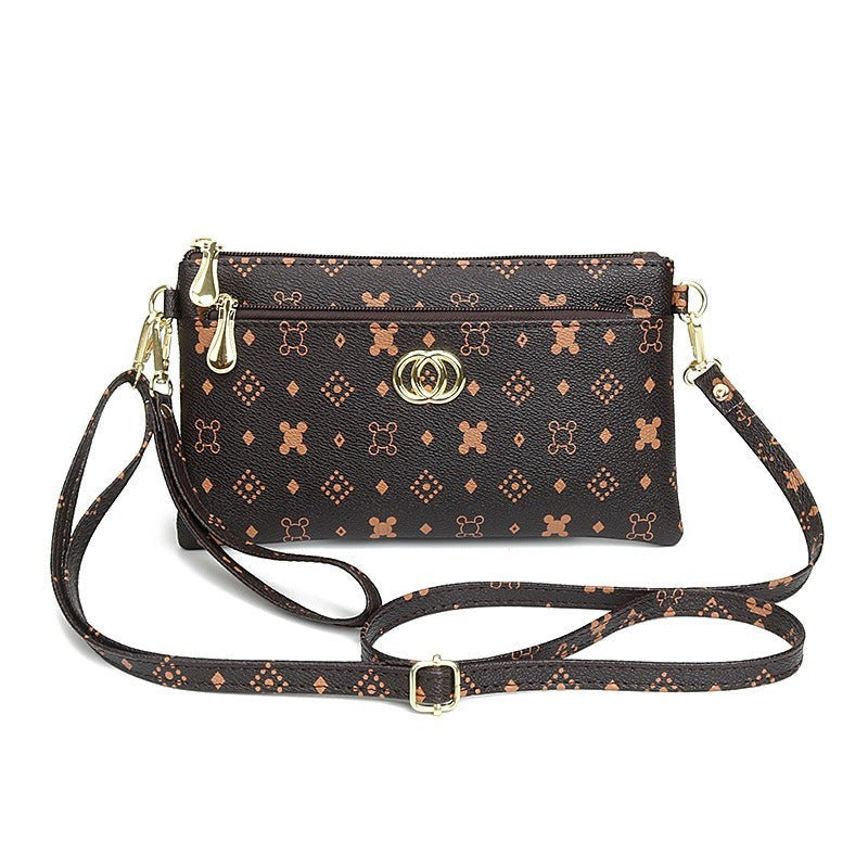 URHER Dion vintage print mini crossbody bag in brown with gold hardware and adjustable strap.