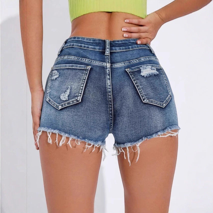 URHER Harlow high-waist distressed denim shorts in blue with frayed hem and pocket details.